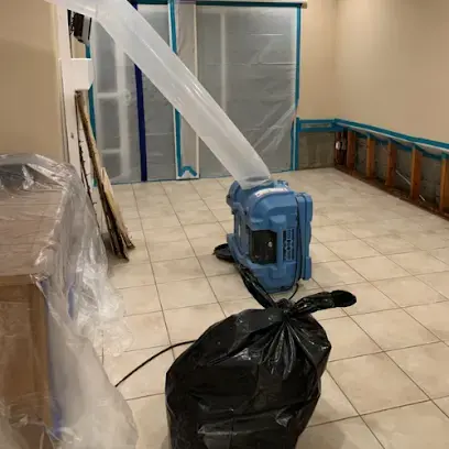 Air scrubber and containment plastic in a tiled room being dried